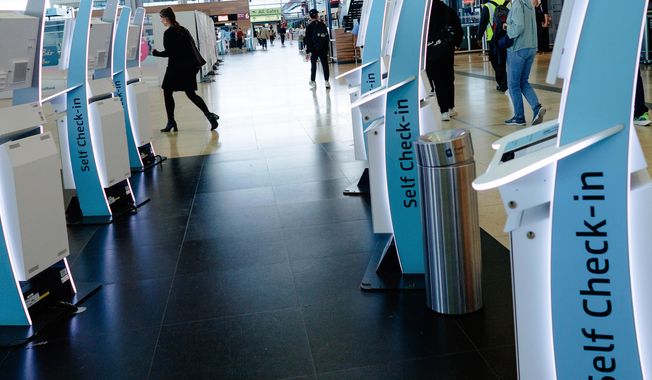 Check-in counters at a terminal at Berlin's Brandenburg airport, in Schönefeld, Germany, Saturday Sept. 20, 2025, after a cyberattack targeting check-in and boarding systems disrupted air traffic at several major European airports. (Carsten Koall/dpa via AP)