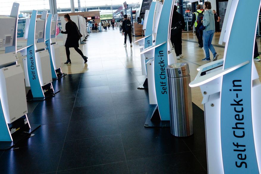 Check-in counters at a terminal at Berlin's Brandenburg airport, in Schönefeld, Germany, Saturday Sept. 20, 2025, after a cyberattack targeting check-in and boarding systems disrupted air traffic at several major European airports. (Carsten Koall/dpa via AP)