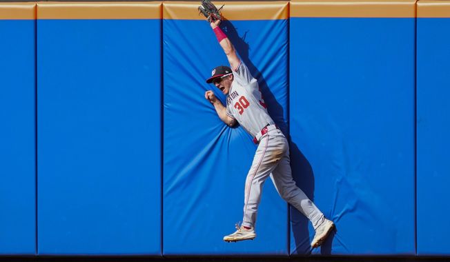 Washington Nationals outfielder Jacob Young catches a fly ball hit by New York Mets' Brett Baty during the fifth inning of a baseball game Sunday, Sept. 21, 2025, in New York. (AP Photo/Yuki Iwamura)