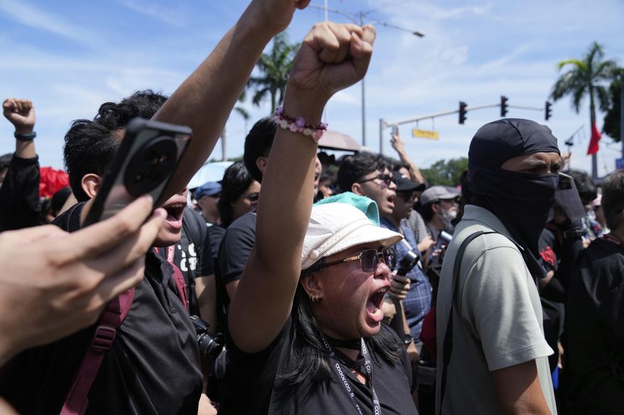 Protesters shout slogans during an anti-corruption rally at Manila's Rizal Park, Philippines on Sunday, Sept. 21, 2025. (AP Photo/Aaron Favila)