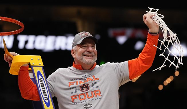 FILE - Auburn head coach Bruce Pearl celebrates with a net after the Elite Eight of the NCAA college basketball tournament against Michigan State, Sunday, March 30, 2025, in Atlanta. (AP Photo/Brynn Anderson, File)