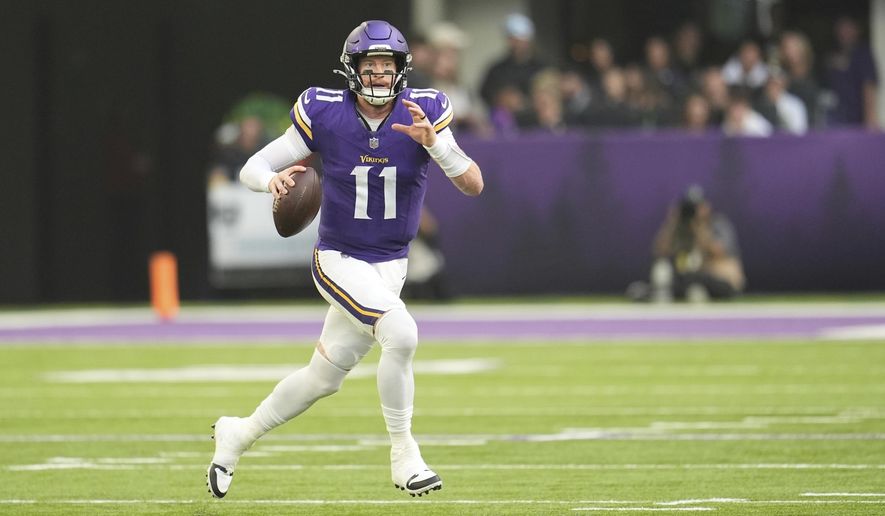 Minnesota Vikings quarterback Carson Wentz looks to throw during the first half of an NFL football game against the Cincinnati Bengals, Sunday, Sept. 21, 2025, in Minneapolis. (AP Photo/Mike Stewart)