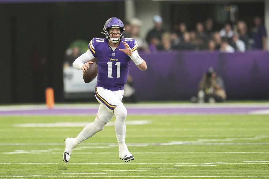 Minnesota Vikings quarterback Carson Wentz looks to throw during the first half of an NFL football game against the Cincinnati Bengals, Sunday, Sept. 21, 2025, in Minneapolis. (AP Photo/Mike Stewart)