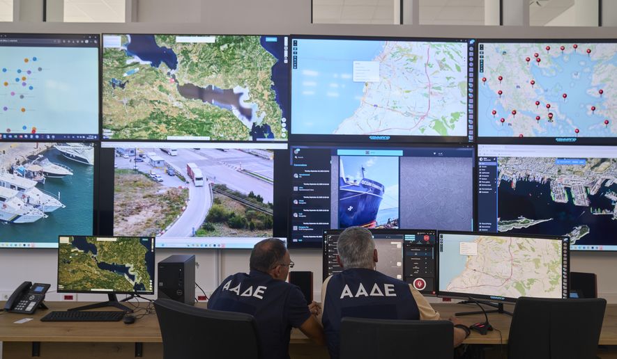 Inspectors of the Independent Authority for Public Revenue monitor transactions in real time at the headquarters of AADE in Athens, Greece, Tuesday, Sept. 16, 2025. (AP Photo/Petros Giannakouris)