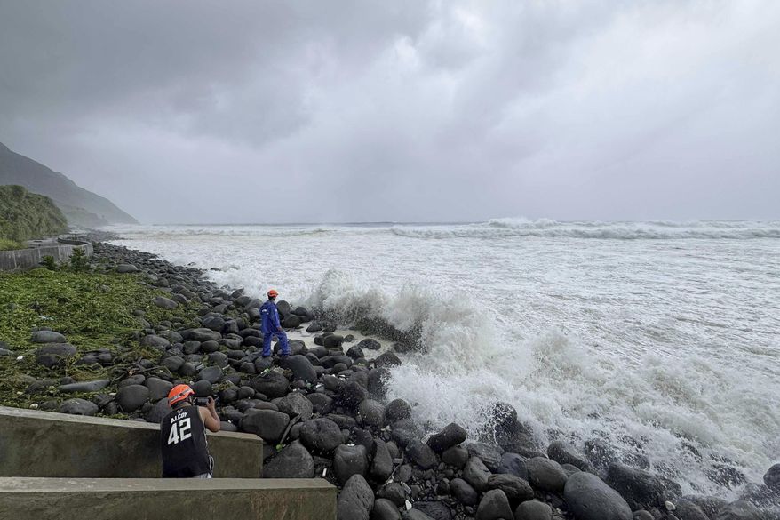 People watch as strong waves batter Basco, Batanes province, northern Philippines as Typhoon Ragasa affects the area on Monday, Sept. 22, 2025. (AP Photo/Justine Mark Pillie Fajardo)