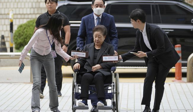 Hak Ja Han, bottom center, the leader of South Korea's Unification Church, arrives at Seoul Central District Court in Seoul, South Korea Monday, Sept. 22, 2025. (AP Photo/Lee Jin-man)