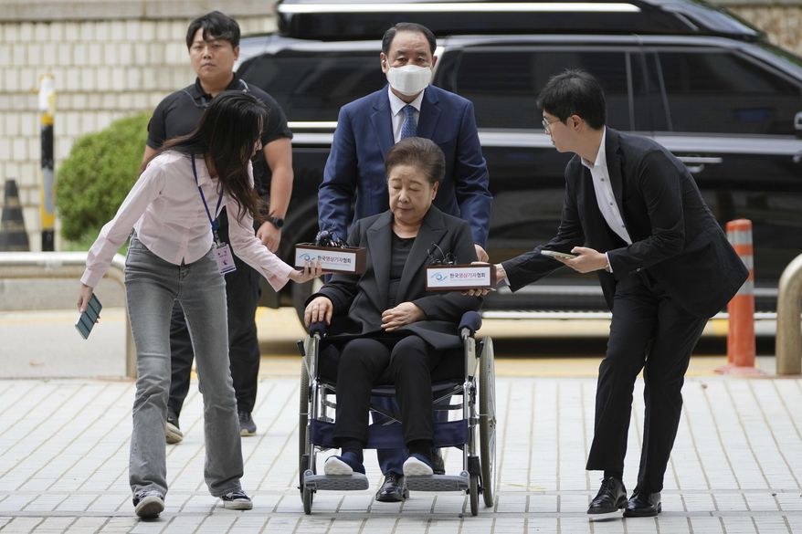 Hak Ja Han, bottom center, the leader of South Korea's Unification Church, arrives at Seoul Central District Court in Seoul, South Korea Monday, Sept. 22, 2025. (AP Photo/Lee Jin-man)