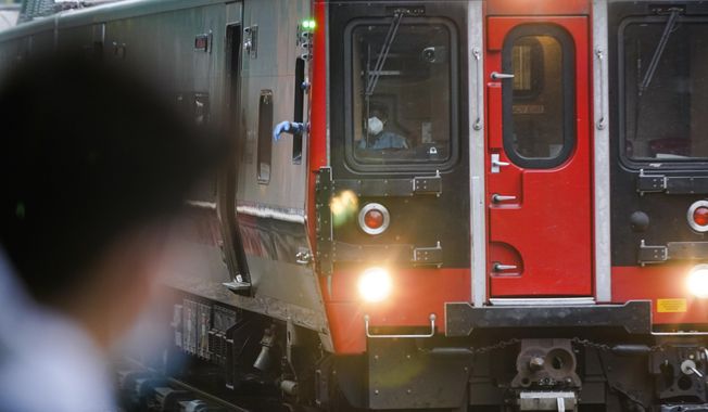 FILE - A train operator watches a train at the Fordham Metro North station Thursday, Oct. 22, 2020, in New York. (AP Photo/Frank Franklin II, File)