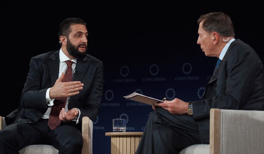 Syrian President Ahmed al-Sharaa, left, speaks with former United States Army General David Howell Petraeus, right, during the Concordia Annual Summit, in New York, Monday, Sept. 22, 2025. (AP Photo/Andres Kudacki)