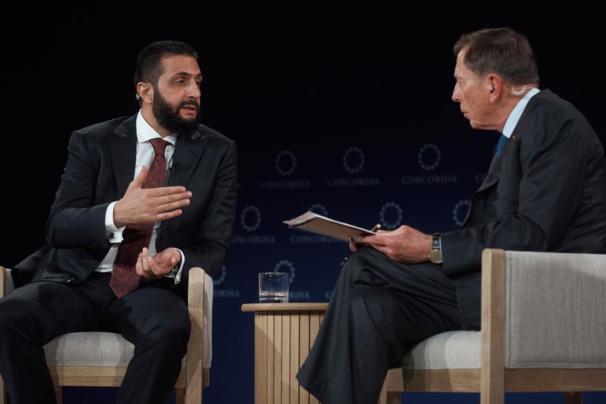 Syrian President Ahmed al-Sharaa, left, speaks with former United States Army General David Howell Petraeus, right, during the Concordia Annual Summit, in New York, Monday, Sept. 22, 2025. (AP Photo/Andres Kudacki)