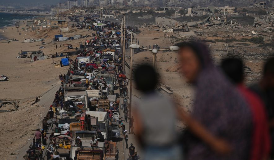 Displaced Palestinians flee northern Gaza Strip, by foot and in vehicles, carrying their belongings along the coastal road, near Wadi Gaza, Tuesday, Sept. 23, 2025. (AP Photo/Abdel Kareem Hana)