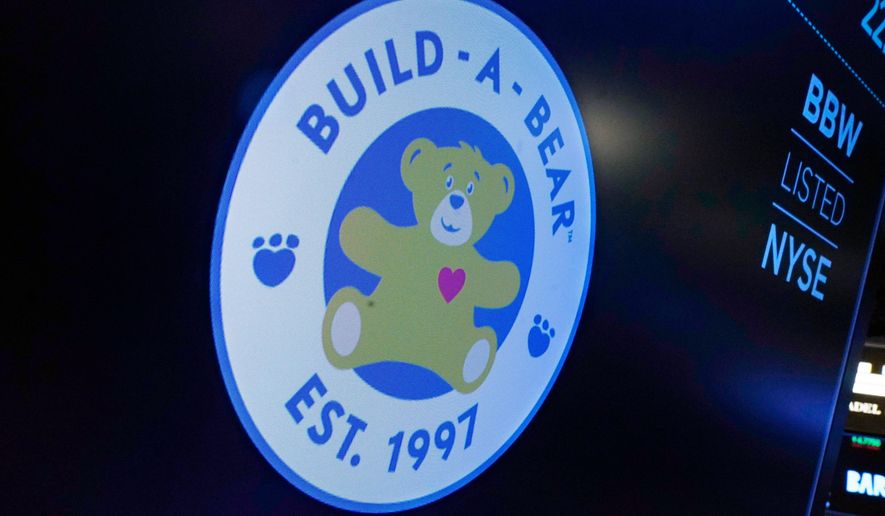 FILE - The logo for Build-A-Bear Workshop appears above a trading post on the floor of the New York Stock Exchange, Wednesday, Dec. 1, 2021. (AP Photo/Richard Drew, file)