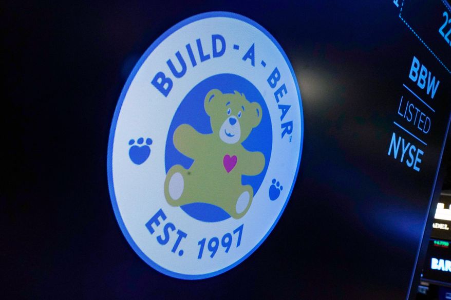 FILE - The logo for Build-A-Bear Workshop appears above a trading post on the floor of the New York Stock Exchange, Wednesday, Dec. 1, 2021. (AP Photo/Richard Drew, file)