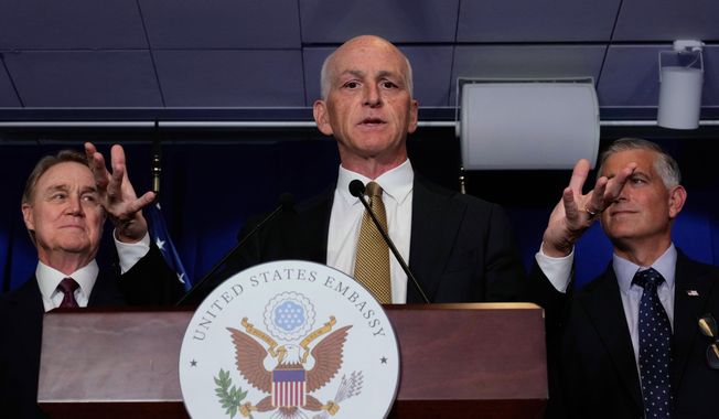 U.S. Rep. Adam Smith, D-Wash, center, speaks during a press conference at the U.S. Embassy in Beijing, China, Tuesday, Sept. 23, 2025. (AP Photo/Mahesh Kumar A.)