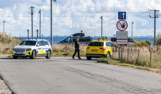 Danish police and Danish Security and Intelligence Service (PET) are present at DSB on Kystvejen by Copenhagen Airport, Tuesday, Sept. 23, 2025, after drones flew over Copenhagen Airport on Monday evening and the airspace was closed for four hours. (Steven Knap/Ritzau Scanpix via AP)
