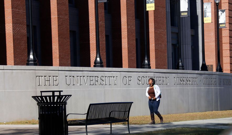 FILE - A student walks across the University of Southern Mississippi School of Business in Hattiesburg, Miss., Nov. 21, 2016. (AP Photo/Rogelio V. Solis, File)
