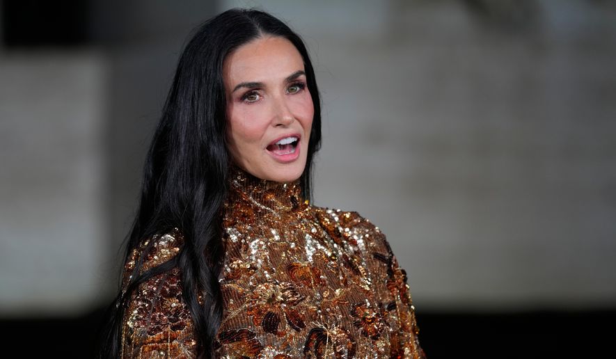 Demi Moore arrives for the premiere of the short film "The Tiger," directed by Spike Jonze and Halina Reijn, featuring the first looks by Gucci's new creative director, Demna, in Milan, northern Italy, Tuesday, Sept. 23, 2025. (AP Photo/Luca Bruno)