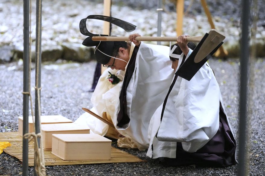 A Shinto priest and a girl called "monoimi" participate in Yamaguchisai, a kickoff ceremony of Shikinen Sengu, concluding in 2033, at Toyoukedaijingu, also known as Geku, or the outer sanctuary, of the Jingu shrine complex in Ise, central Japan, Friday, May 2, 2025. (AP Photo/Hiro Komae)