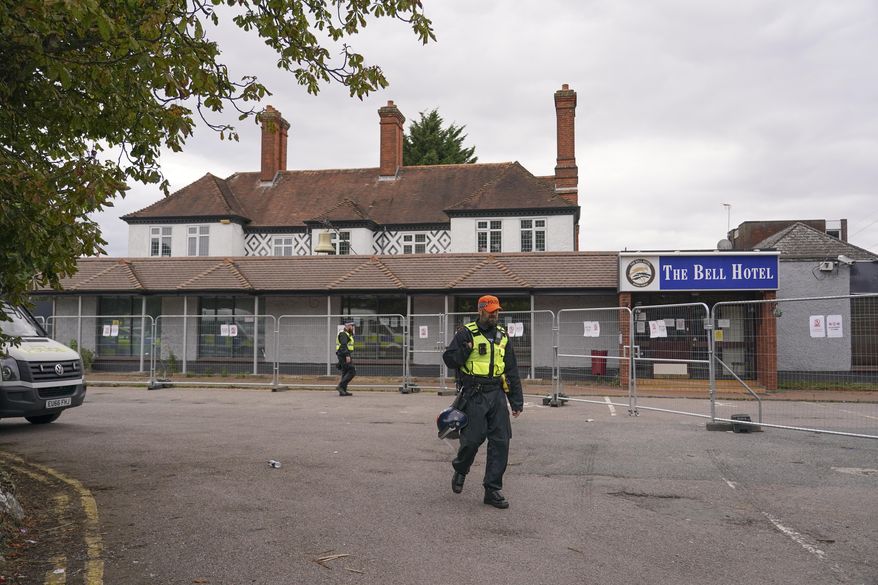 FILE - A police officer walks outside The Bell Hotel in Epping, near London, Sunday, July 27, 2025. (AP Photo/Alberto Pezzali, File)