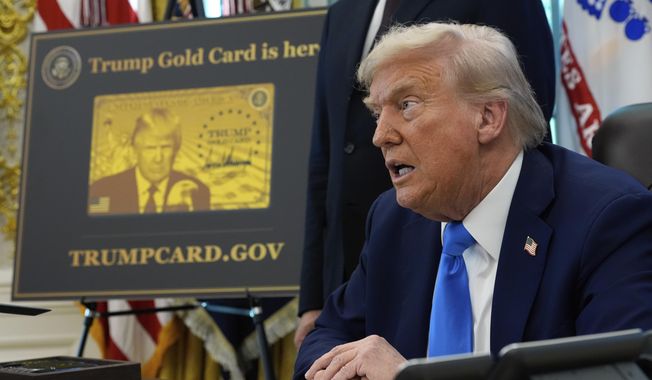 A poster showing the Trump Gold Card is seen as President Donald Trump signs executive orders in the Oval Office of the White House, Friday, Sept. 19, 2025, in Washington. (AP Photo/Alex Brandon)