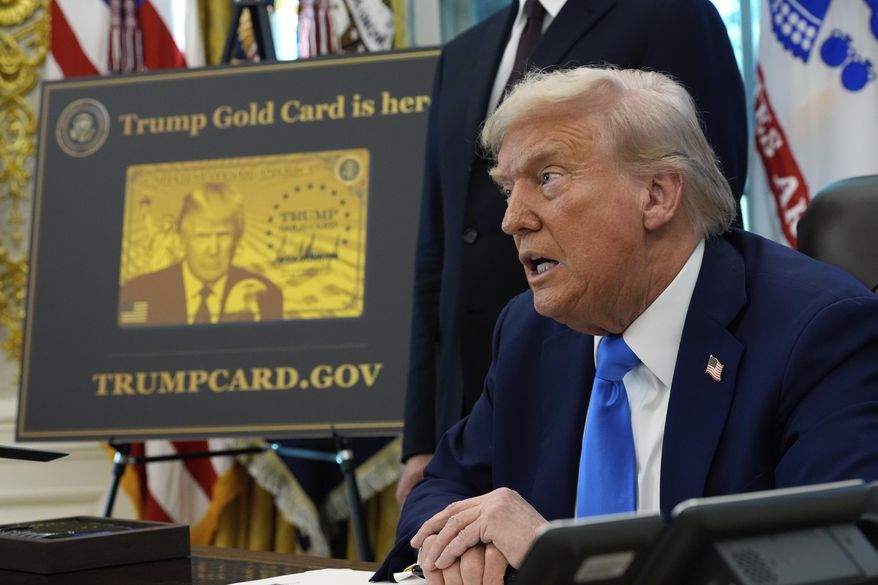A poster showing the Trump Gold Card is seen as President Donald Trump signs executive orders in the Oval Office of the White House, Friday, Sept. 19, 2025, in Washington. (AP Photo/Alex Brandon)