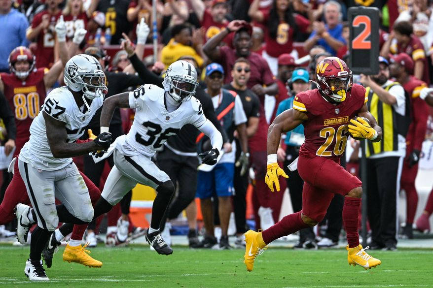 Washington Commanders running back Jeremy McNichols (26) breaks free for a career-long 60-yard touchdown run against the Las Vegas Raiders at Northwest Stadium in Landover, Maryland, September 21, 2025. (Photo by Brian Murphy for the Washington Times)