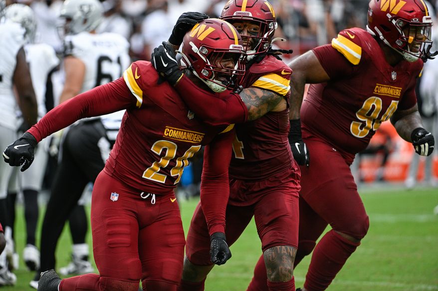 Washington Commanders linebacker Von Miller (24) celebrates with linebacker Frankie Luvu (4) after collecting his first sack with the franchise against the Las Vegas Raiders at Northwest Stadium in Landover, Maryland, September 21, 2025. (Photo by Brian Murphy for the Washington Times)