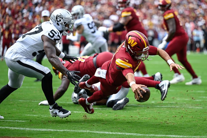 Washington Commanders quarterback Marcus Mariota (8) dives into the end zone for a two-yard touchdown against the Las Vegas Raiders at Northwest Stadium in Landover, Maryland, September 21, 2025. (Photo by Brian Murphy for the Washington Times)