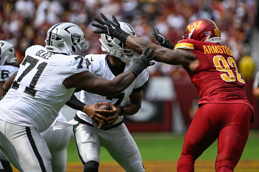 Washington Commanders defensive end Dorance Armstrong (92) sacks Las Vegas Raiders quarterback Geno Smith (7) for his third sack in three games at Northwest Stadium in Landover, Maryland, September 21, 2025. (Photo by Brian Murphy for the Washington Times)