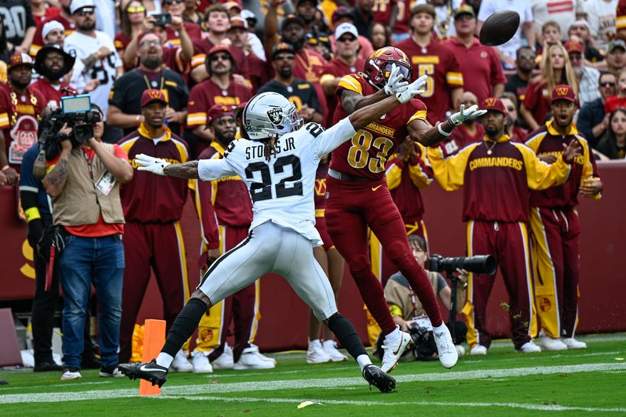 Washington Commanders receiver Jaylin Lane (83) jumps for a contested catch against Las Vegas Raiders cornerback Eric Stokes (22) at Northwest Stadium in Landover, Maryland, September 21, 2025. (Photo by Brian Murphy for the Washington Times)