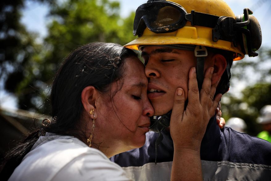 Yuliana Andrea Agudelo embraces her son Sebastian Agudelo after he was rescued from a gold mine that had collapsed trapping over 20 miners, in Segovia, Colombia, Wednesday, Sept. 24, 2025. (AP Photo/Santiago Saldarriaga)