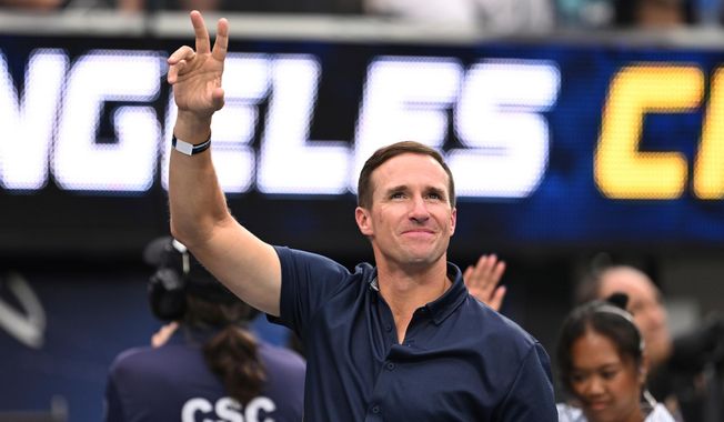 FILE - Drew Brees waves to the crowd during the first half of an NFL football game between the Los Angeles Chargers and the Denver Broncos, Sunday, Sept. 21, 2025, in Inglewood, Calif. (AP Photo/Carrie Giordano, file)