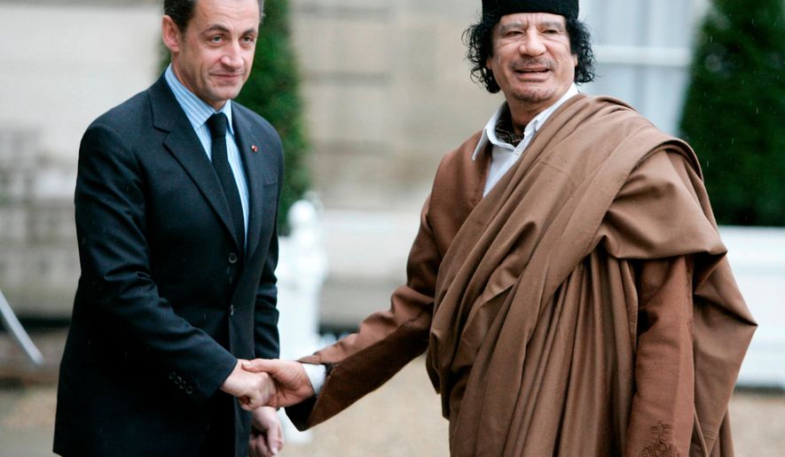 FILE - French President Nicolas Sarkozy, left, greets Libyan leader Col. Moammar Gadhafi upon his arrival on Dec. 10 2007 at the Elysee Palace, in Paris. (AP Photo/Francois Mori, File)