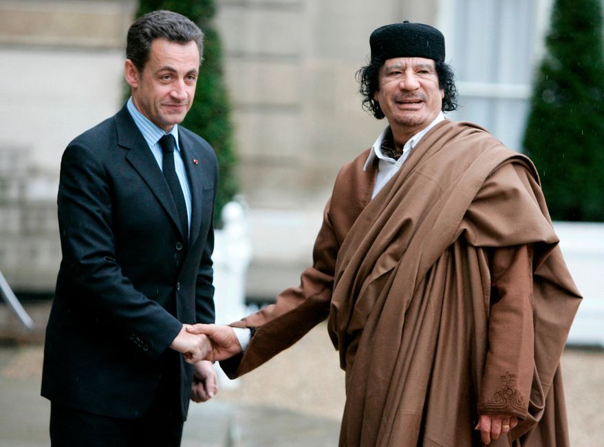 FILE - French President Nicolas Sarkozy, left, greets Libyan leader Col. Moammar Gadhafi upon his arrival on Dec. 10 2007 at the Elysee Palace, in Paris. (AP Photo/Francois Mori, File)