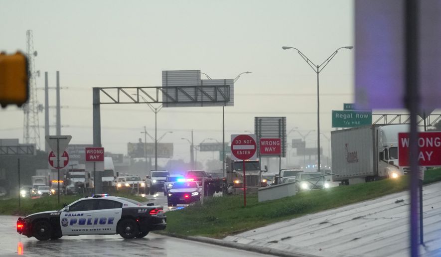 Police block off the street close to a U.S. Immigration and Customs Enforcement office after a reported shooting, in Dallas on Wednesday, Sept. 24, 2025. (AP Photo/Julio Cortez)
