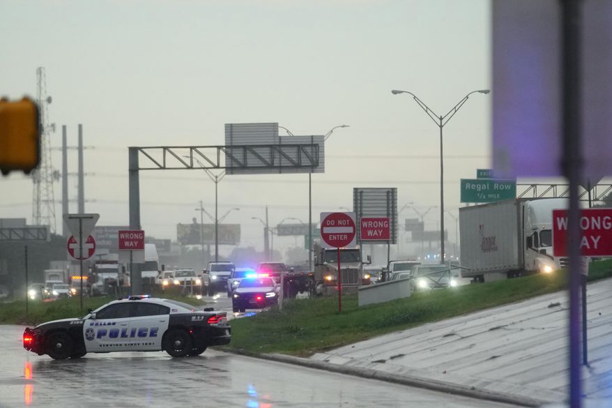Police block off the street close to a U.S. Immigration and Customs Enforcement office after a reported shooting, in Dallas on Wednesday, Sept. 24, 2025. (AP Photo/Julio Cortez)