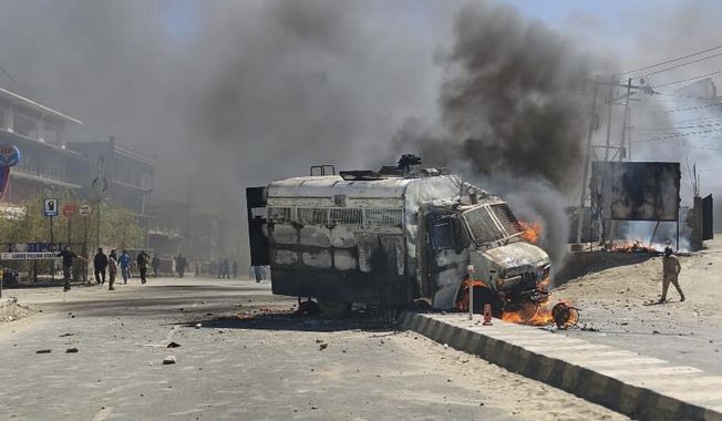 A police vehicle is set on fire during a protest by locals demanding federal statehood from the Indian government, in the high-altitude Leh town, in the region of Ladakh, India, Wednesday, Sept. 24, 2025. (AP Photo)