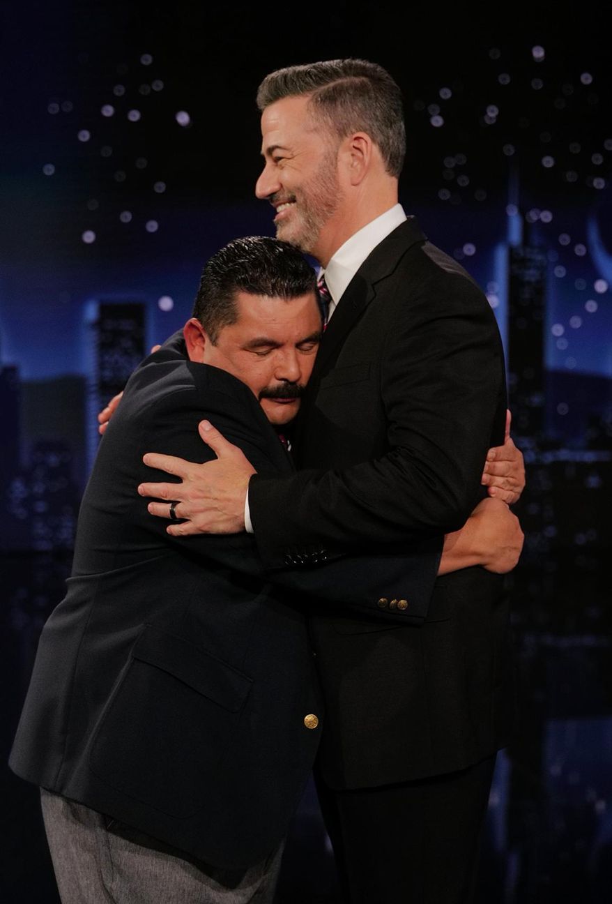 This image released by Disney shows host Jimmy Kimmel being embraced by Guillermo Rodriguez on "Jimmy Kimmel Live!" in Los Angeles on Tuesday, Sept. 23, 2025. (Randy Holmes/Disney via AP)