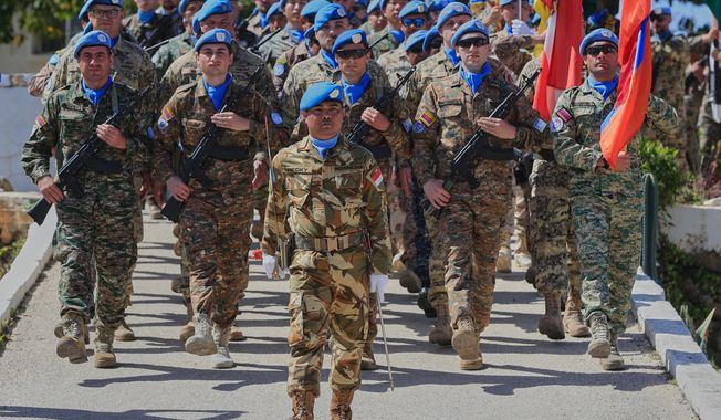 FILE - U.N. peacekeepers from different national contingents march during a ceremony to mark the 47th anniversary of UNIFIL Establishment Day, at the United Nation Peacekeepers headquarters in the southern Lebanese town of Naqoura, Lebanon, March 19, 2025. (AP Photo/Mohammed Zaatari, File)