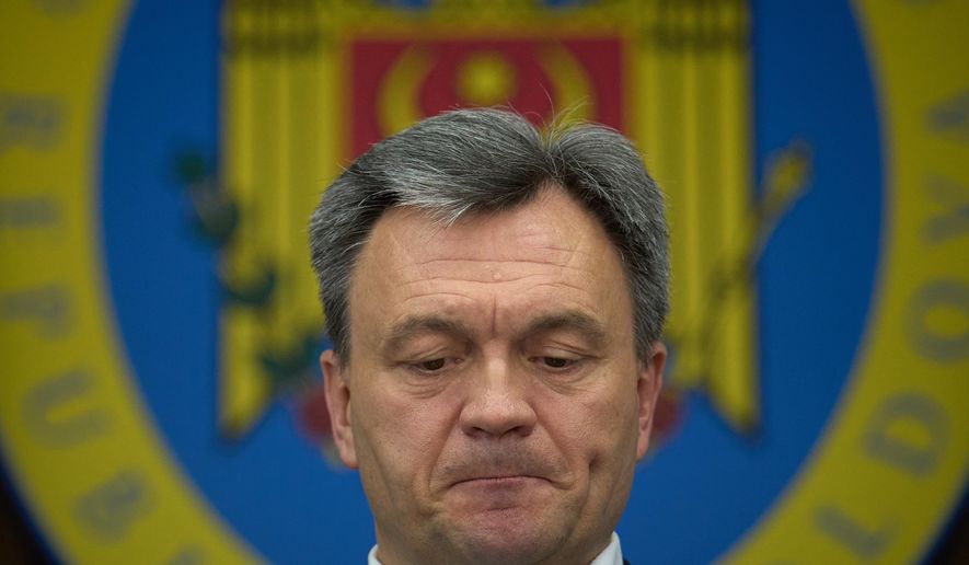 Moldova's Prime Minister Dorin Recean grimaces during statements on Russia's attempts to interfere in the country's upcoming Sept. 28 parliamentary elections in Chisinau, Moldova, Wednesday, Sept. 24, 2025. (AP Photo/Vadim Ghirda)