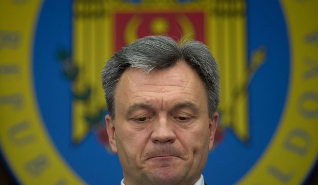 Moldova's Prime Minister Dorin Recean grimaces during statements on Russia's attempts to interfere in the country's upcoming Sept. 28 parliamentary elections in Chisinau, Moldova, Wednesday, Sept. 24, 2025. (AP Photo/Vadim Ghirda)