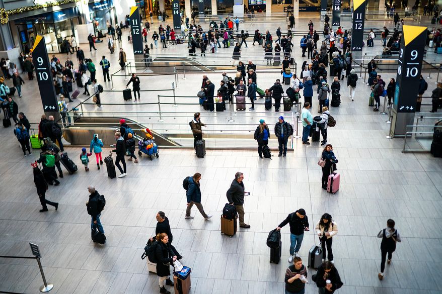 FILE - Travelers look for their gates to catch their trains departing at Penn Station in New York, Dec. 21, 2023. (AP Photo/Eduardo Munoz Alvarez, File)