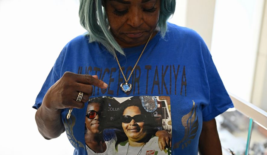 FILE - Nadine Young, grandmother of Ta'Kiya Young, shows her shirt to reporters after arraignment proceedings of Blendon Township police officer Connor Grubb, Aug. 14, 2024, at the Franklin County Court of Common Pleas in Columbus, Ohio. (AP Photo/David Dermer, File)