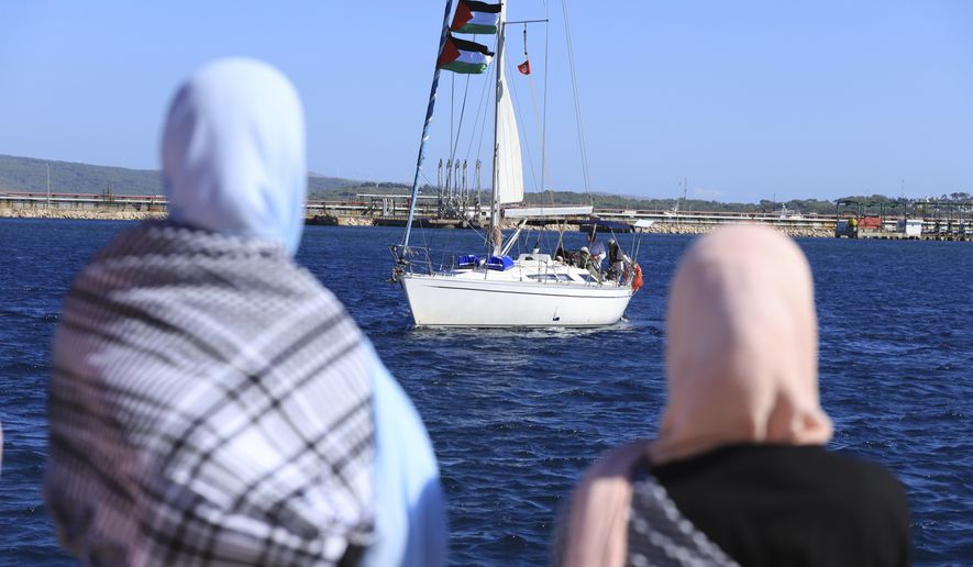 Supporters watch as a boat that is part of the Global Sumud Flotilla departs to Gaza to deliver aid amidst Israel's blockade on the Palestinian territory, in the Tunisian port of Bizerte, Saturday, Sept. 13, 2025. (AP Photo/Anis Mili)