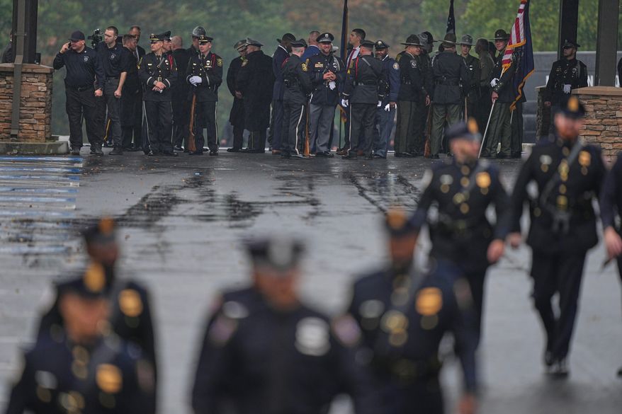 Officers gather ahead of funeral services for slain Northern York County Regional Police detectives Cody Michael Becker, Mark Edward Baker and Isaiah Emenheiser, Thursday, Sept. 25, 2025, in Red Lion, Pa. (AP Photo/Matt Rourke)