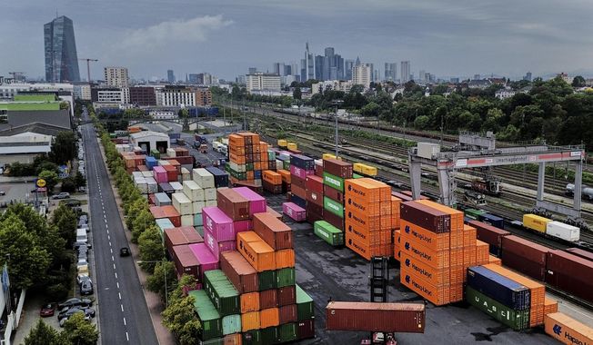 Containers are piled upon a cargo terminal in Frankfurt, Germany, Tuesday, Sept. 9, 2025. (AP Photo/Michael Probst)