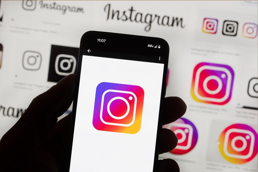 The Instagram logo is seen on a cell phone in Boston, Oct. 14, 2022. (AP Photo/Michael Dwyer, File)