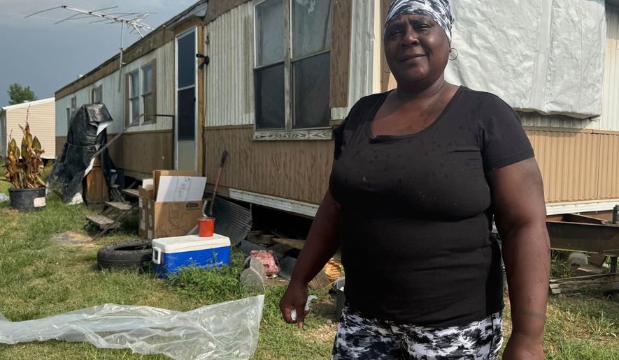 Kathy Lampley stands in front of her trailer in Delhi, La., Monday, Aug. 18, 2025. (AP Photo/Sophie Bates)