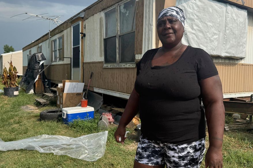 Kathy Lampley stands in front of her trailer in Delhi, La., Monday, Aug. 18, 2025. (AP Photo/Sophie Bates)