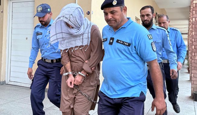 Police officers escorts a suspect Umar Hayat, second left, who allegedly killed a teenage social media influencer Sana Yousaf, following his court appearance in Islamabad, Pakistan, Thursday, Sept. 25, 2025. (AP Photo/Muhammad Yousuf)